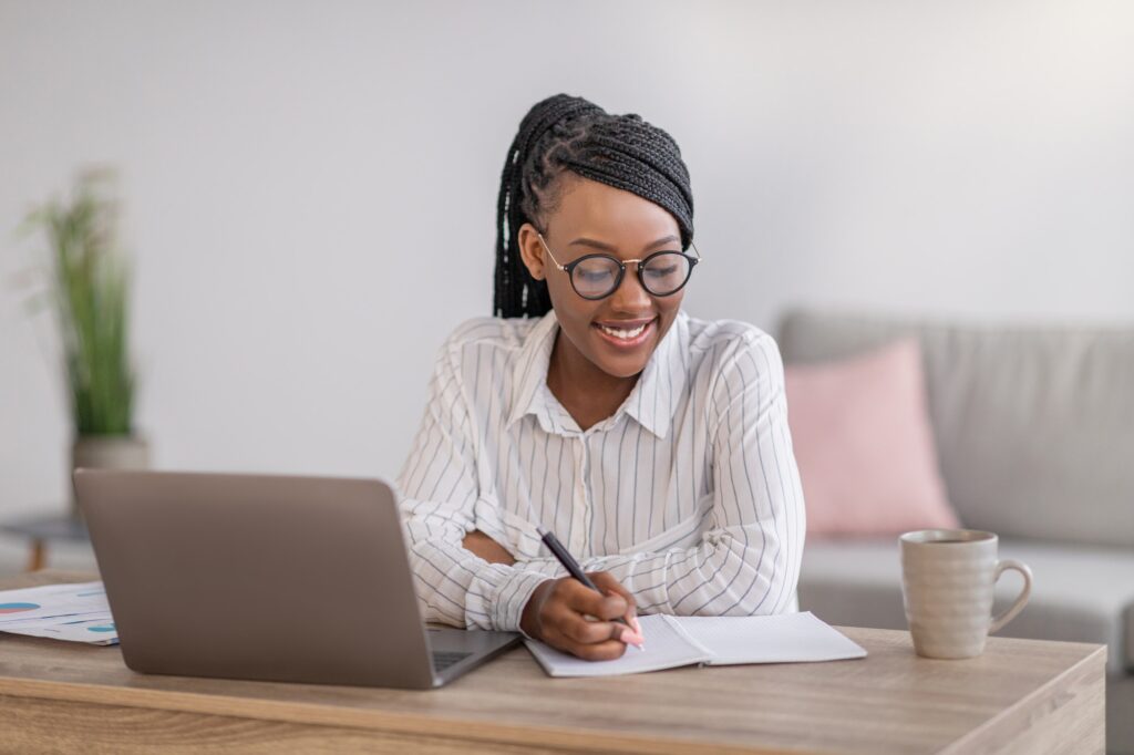 Positive black business woman working from home