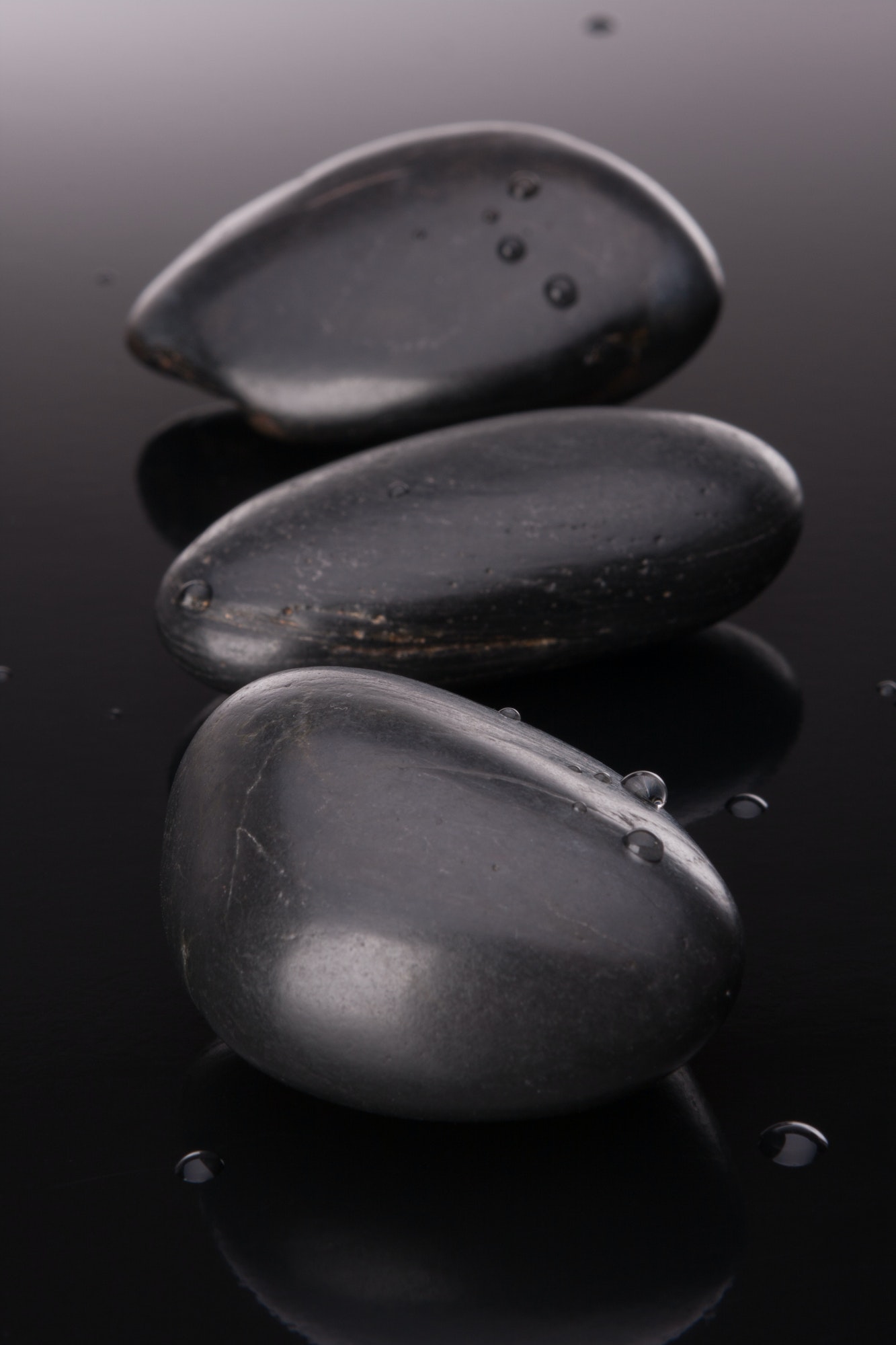 Spa stone arrangement on black surface. Healthcare concept.